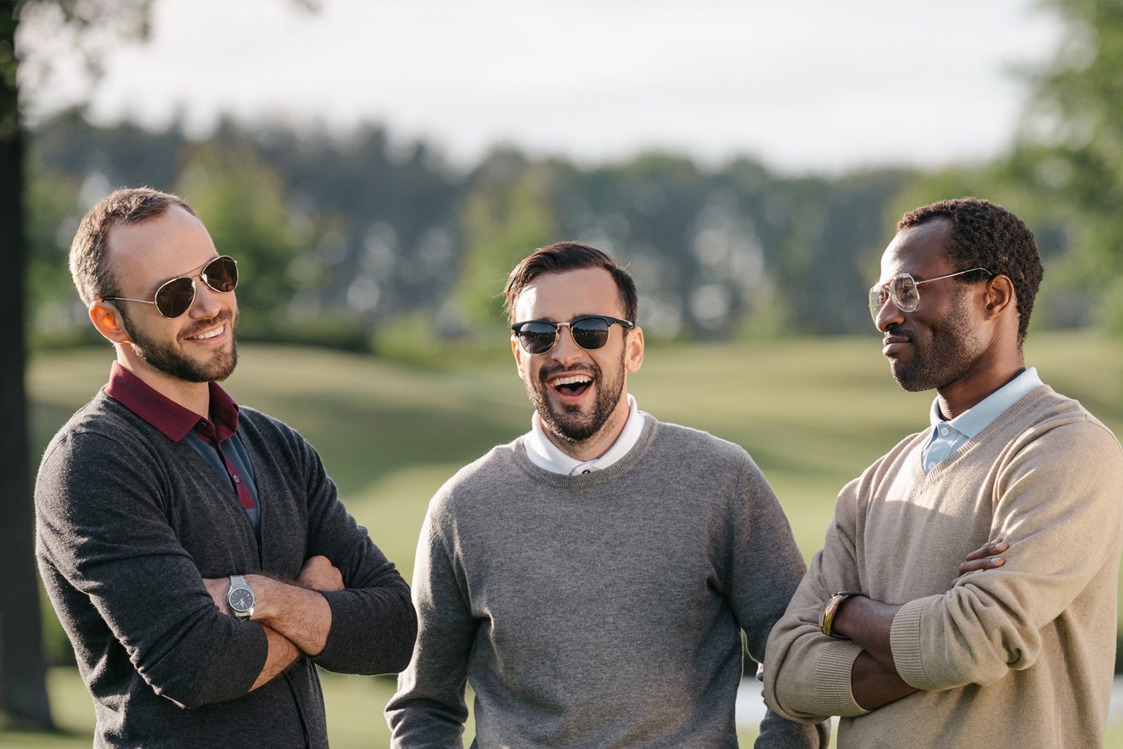 Three men playing golf discussing their mental wellbeing