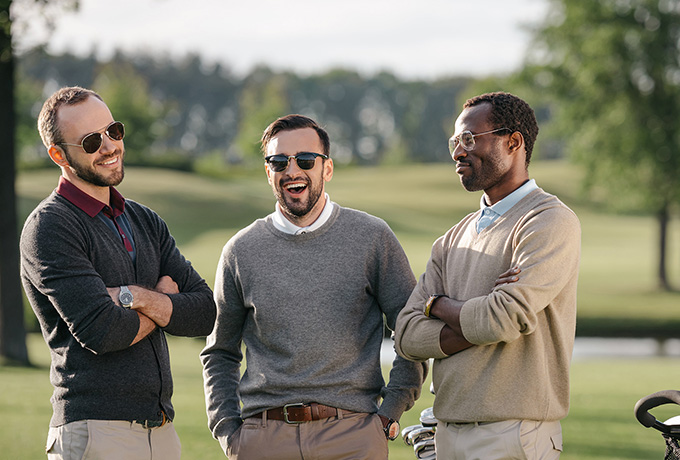Three men playing golf discussing their mental wellbeing