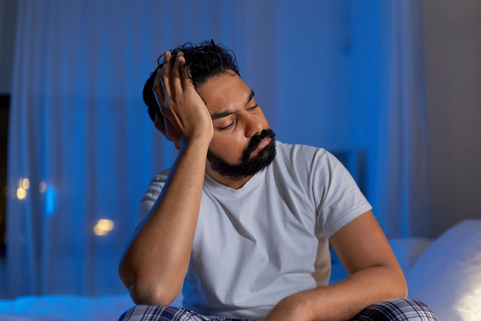 man trying to sleep suffering from burnout