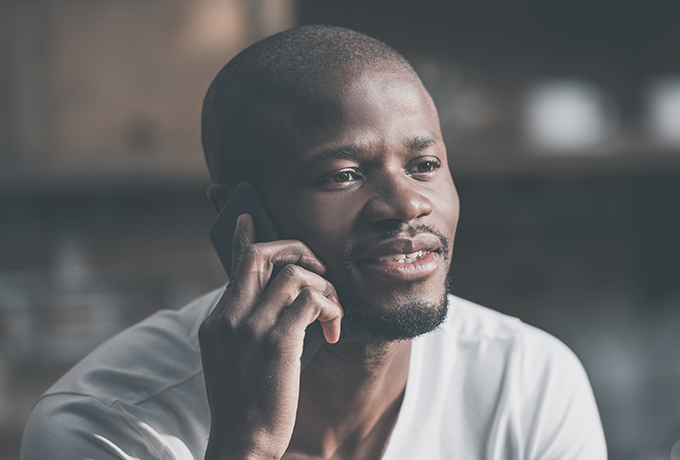 Man calling MensLine Australia talking on the phone