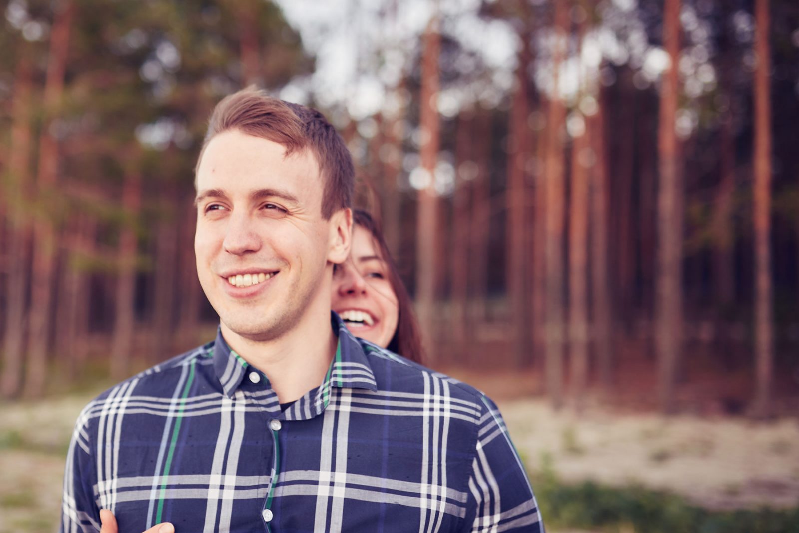 Man and women laughing together whilst walking
