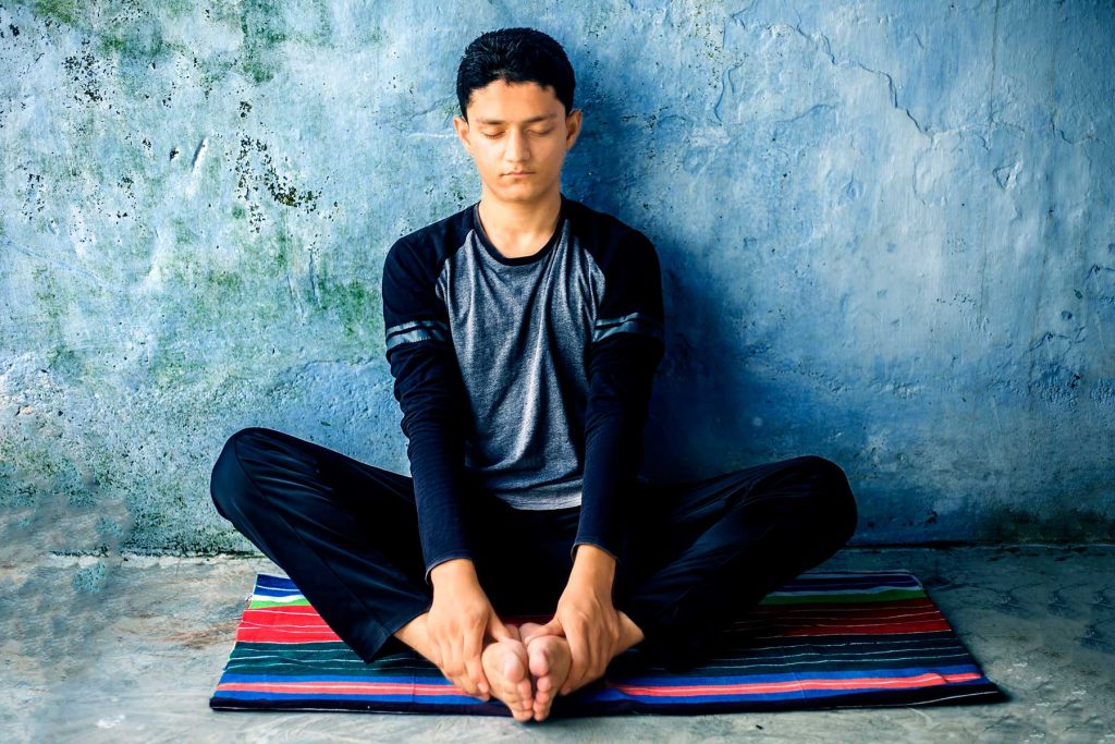 Young man doing a breathing exercise