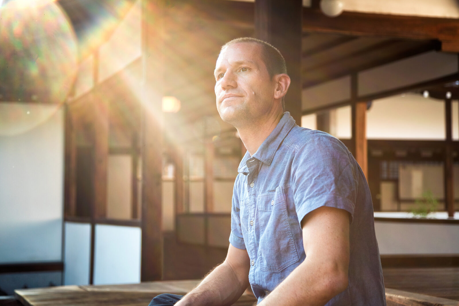 Man sitting and looking serious and hopeful